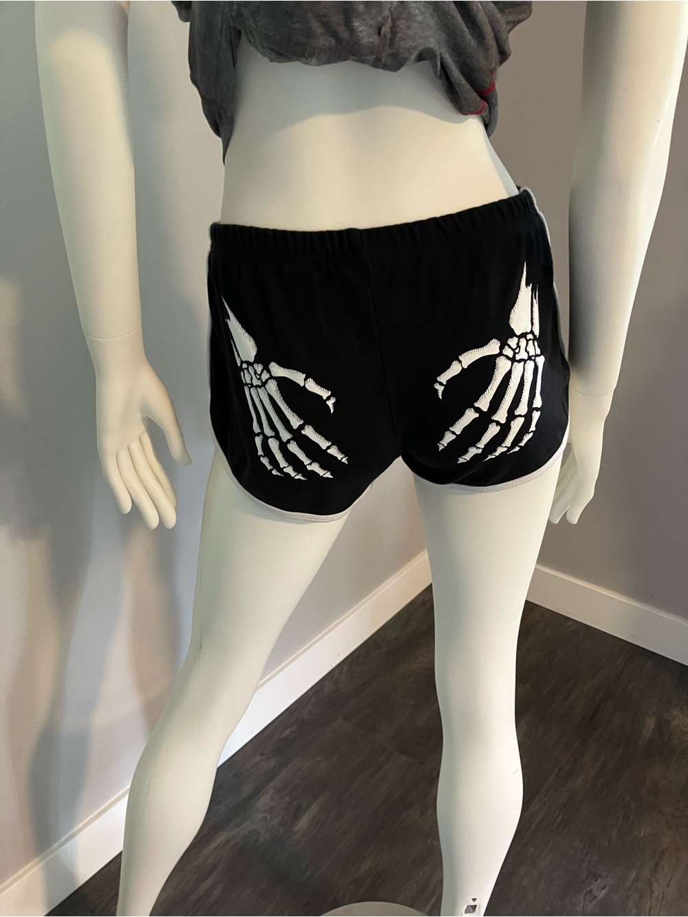 Roller derby bootie shorts with skull hands.